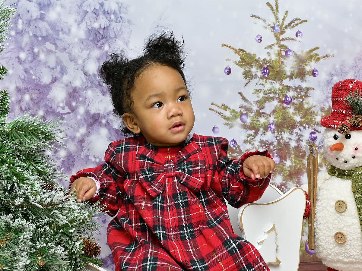 Photo of a baby posing in a Christmas scene