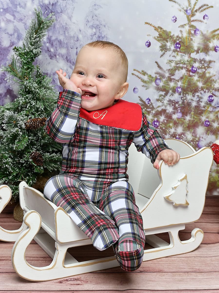 Photo of a baby smiling with joy in a Christmas scene